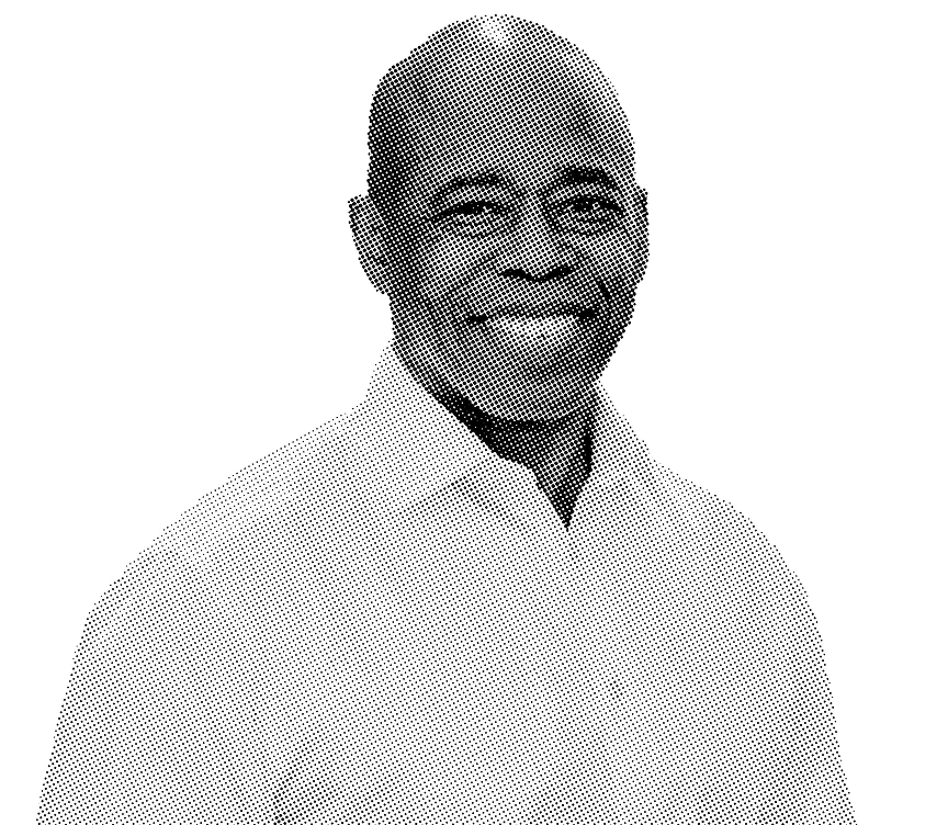 Black and white portrait of Eric Adams, smiling, wearing a light shirt.