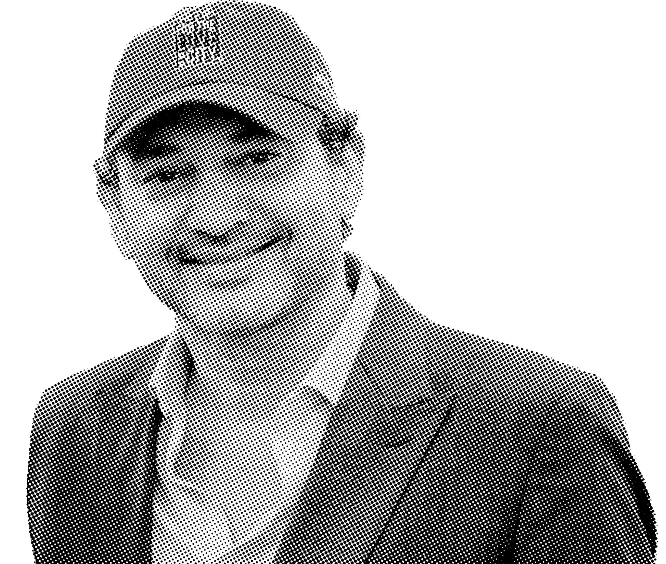 Black and white portrait of Joseph Hernandez smiling with a hat and suit.